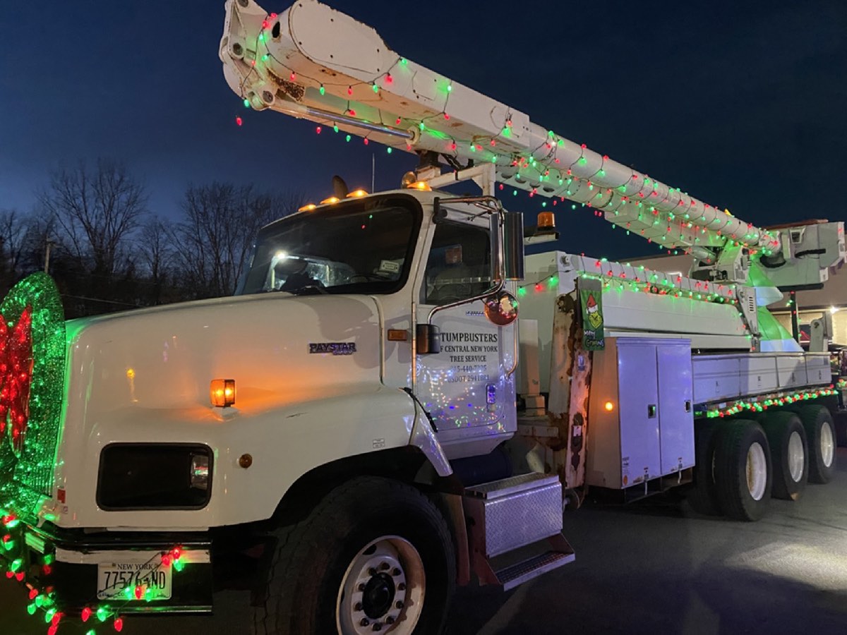 The Stumpbusters truck decorated with holiday lights for a community event